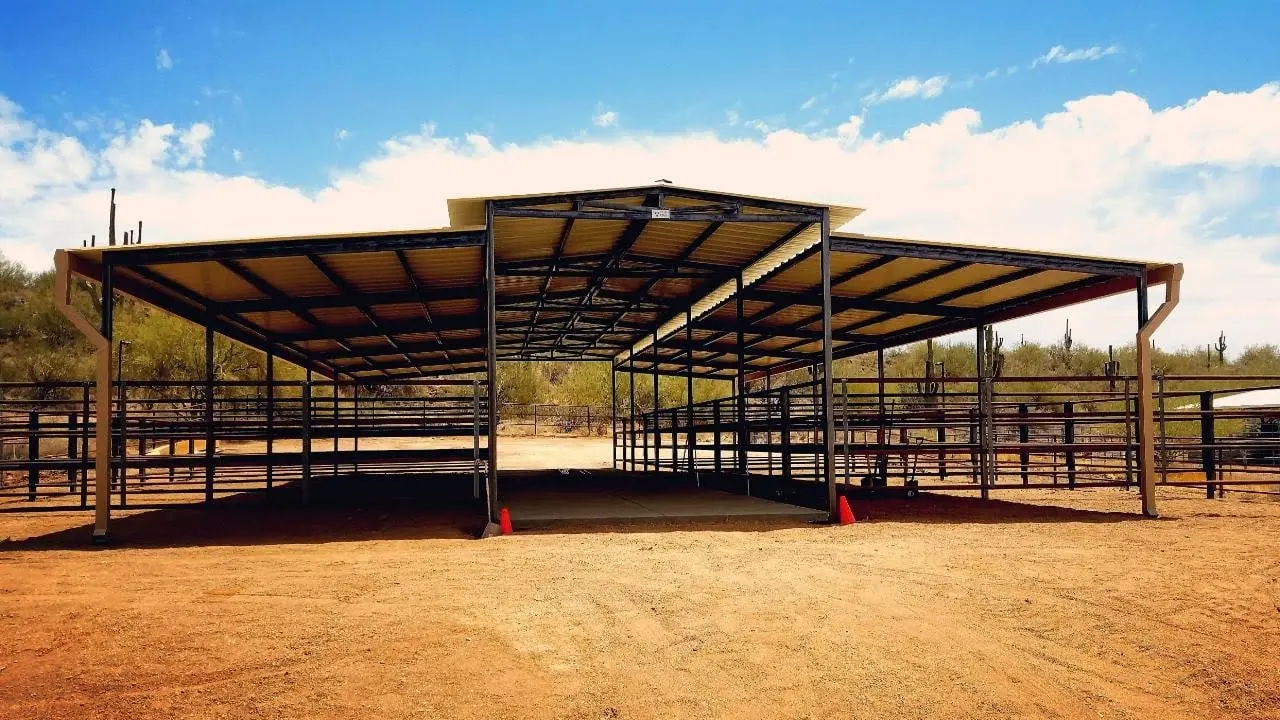 A Corral Kraft mare motel with stalls on both sides and a raised breezeway roof down the centre, built on desert ground